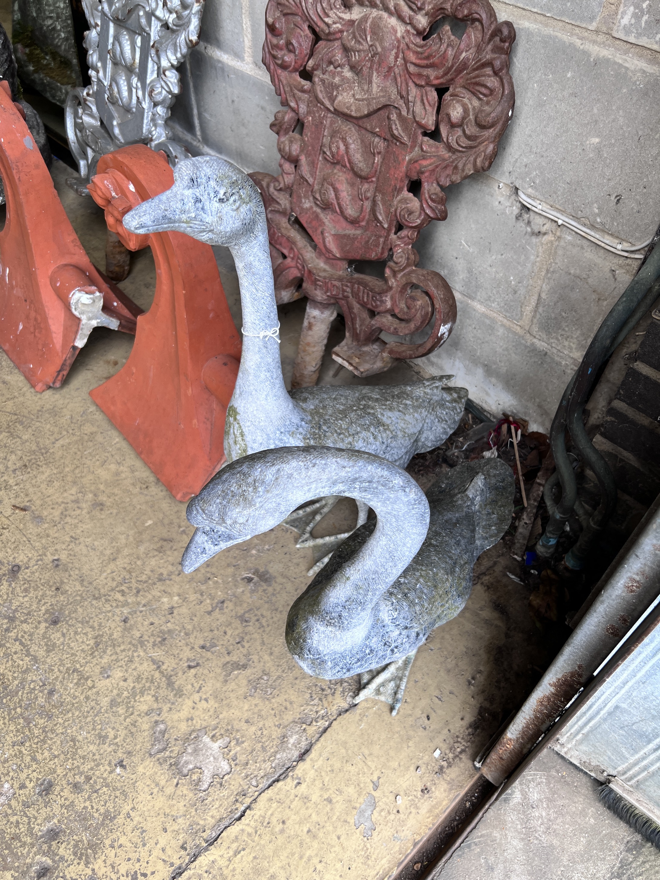 A pair of oxidised metal garden ornaments modelled as geese, height 73cm